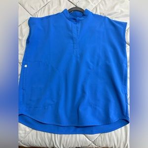 Royal blue oversized scrub shirt. 2 pockets, in royal blue.